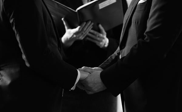 Close up of hands of two Grooms during a wedding ceremony